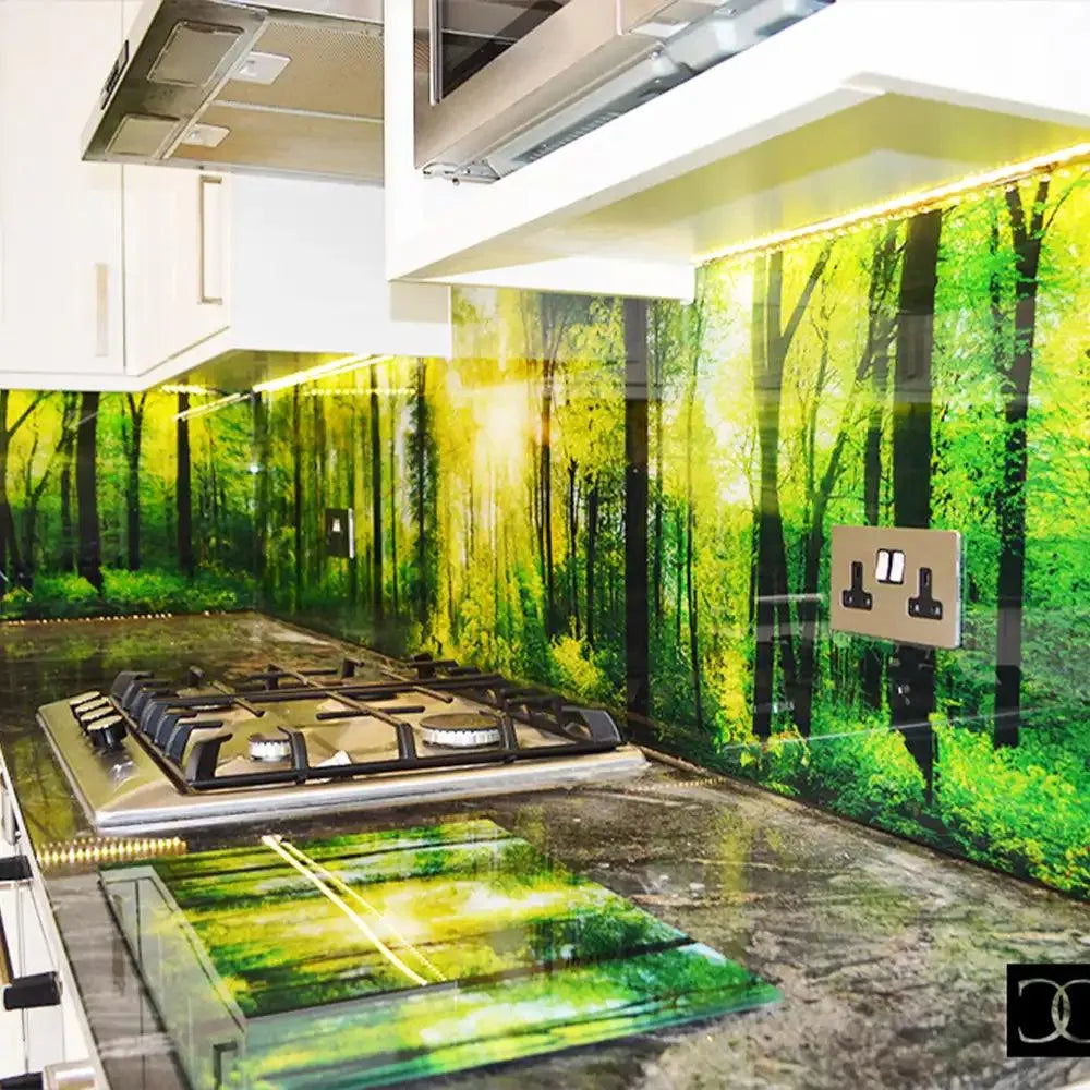 Forest-themed glass backsplash with LED lighting in modern kitchen, featuring bespoke decorative glass design