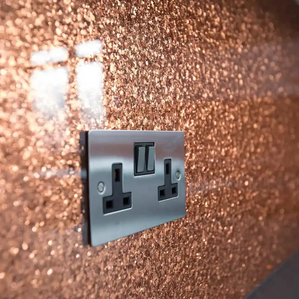 Luxury decorative glass wall with metallic sparkle and modern UK plug sockets