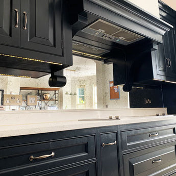 Antique mirror splashback with a distressed reflective finish in a bespoke kitchen