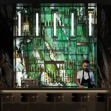 Bar with a decorative LED wall displaying bottles, featuring a bartender.