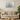 Modern living room with beige sofa, green pillows, wooden coffee table, silver glitter wall art
