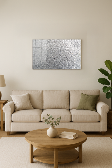 Modern living room with beige sofa, green pillows, wooden coffee table, silver glitter wall art