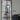 Modern double hinged glass door with black frame opening between living areas with sofas