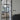 Modern double hinged glass door with black frame in a bright living room interior
