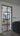 Modern interior with black metal-framed glass double hinged door and cozy living room