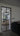 Modern black double hinged glass door with frame in a contemporary living room interior