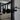Close-up of modern black metal double hinged glass door with black knobs in a stylish living room