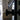 Close-up of black metal door knob on a double hinged glass door with black frame in a modern interior