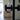 Close-up of modern black door knob on glass double hinged door in stylish living room
