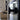 Close-up of matte black iron door handle on glass double hinged door in modern living room