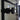 Close-up of modern black metal door handle on glass double hinged door with frame in bright room