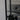Black double hinged glass door with round black handles in modern interior