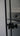Black double hinged glass door with round black handles in modern interior