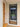 Modern black framed glass hinged door installed indoors, next to wooden door and beige walls