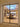 Modern dining room with glass double hinged door, skylight ceiling, wooden table and cream chairs