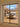 Modern dining room with glass double hinged door, skylight ceiling, wooden table and cream chairs