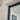 Close-up of white wall corner with black metal door frame and glass panel door indoors
