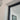 Close-up of white wall corner with black metal door frame and glass panel door indoors