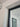 Close-up of white wall corner with black metal door frame and glass panel door indoors