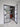 Modern double hinged glass door with black metal frame in a bright interior with white wooden floor