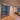 Modern interior with black metal frame double hinged glass doors and hardwood herringbone flooring