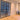 Modern black metal double hinged glass doors with black grid frame in bright room