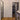 Modern interior with black framed glass doors, wooden floor, and a kitchen countertop with mug