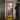 Black framed glass hinged door in hallway leading to modern kitchen with wooden floor