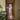 Modern black metal framed glass hinged door in hallway with wooden floor and Christmas tree