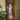 Modern black metal framed glass hinged door in hallway with wooden floor and Christmas tree