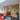 Modern interior with exposed brick wall, black framed glass door, orange sofa, and chess table