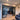 Modern black metal frame double sliding doors with side panels separating living and dining areas