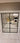 Modern interior with black steel frame double hinged glass doors opening to a furnished living room