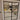 Double hinged black framed glass door opening to a modern living room with beige sofas and chandelier