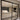 Modern double hinged black metal frame glass door separating tiled hallway and living room
