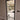 Modern black framed hinged glass door with metal handle in a neutral indoor setting