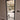 Modern black framed hinged glass door with metal handle in a neutral indoor setting