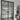 modern double hinged black metal frame glass door in bright indoor room with storage shelves