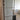 Double hinged glass door with metal frame in modern interior with wooden herringbone floor