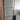 Double hinged glass door with metal frame in modern interior with wooden herringbone floor