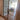 Double hinged glass door with bronze frame and handles, leading to a bright living room
