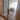 Double hinged glass door with bronze frame and handles, leading to a bright living room