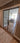 Double hinged glass door with bronze frame and handles, leading to a bright living room
