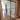 Double hinged glass door with metal frame and handles in modern interior with parquet floor and patterned rug