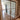 Double hinged glass door with metal frame and handles in modern interior with parquet floor and patterned rug