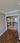 Double hinged glass doors with gold frames and handles in modern interior with wooden herringbone floor