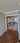 Double hinged glass doors with gold frames and handles in modern interior with wooden herringbone floor