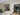 Modern interior with black double hinged glass doors and white marble dining table
