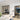 Modern interior with black-framed double hinged glass doors and white marble dining table