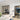 Modern interior with black-framed double hinged glass doors and white marble dining table
